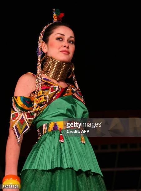 Model displays an ethnically influenced dress by a Turkish designer during a fashion show at the 'Regional Countries General Trade Fair' in the...