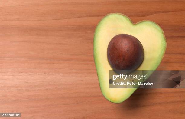 heart shaped avocado, healthy eating - avocado stock pictures, royalty-free photos & images