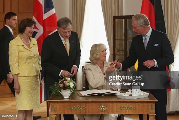 Prince Charles, Prince of Wales, and Camilla, Duchess of Cornwall, sign the presidential geust book as German President Horst Koehler and German...