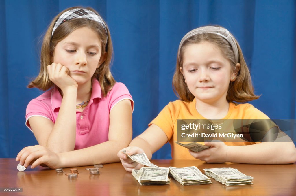 Two girls counting money