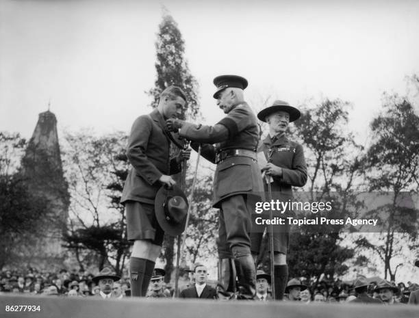 Edward Prince of Wales is invested with a Silver Wolf Award by Prince Arthur, Duke of Connaught , at a Boy Scouts' Rally at Alexandra Palace, London,...