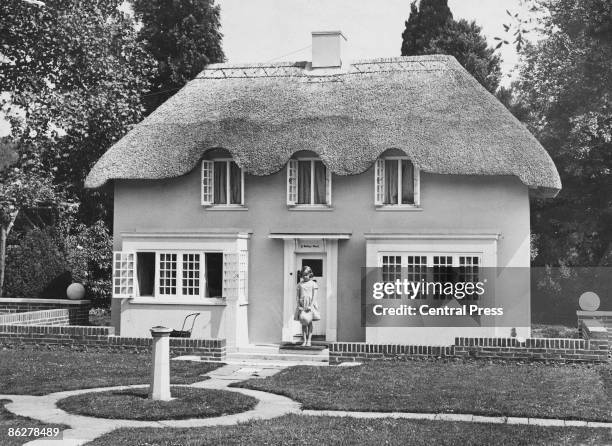 Princess Elizabeth stands in the doorway of Y Bwthyn Bach , situated in the grounds of the Royal Lodge, Windsor, June 1933. The cottage was a gift to...