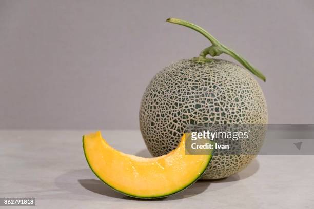 close-up of fresh whole cantaloupe and slices - メロン ストックフォトと画像