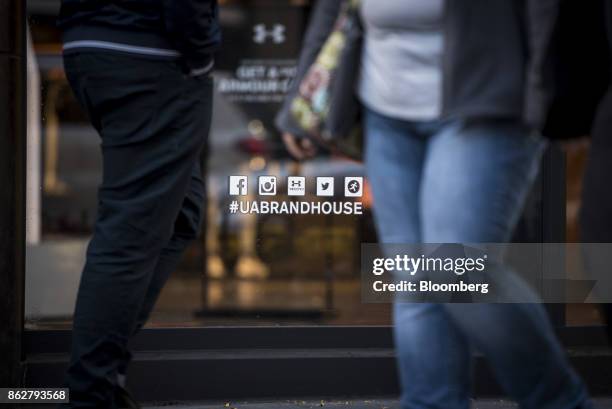 Pedestrians walk past an Under Armour Inc. Store in downtown Chicago, Illinois, U.S., on Monday, Oct. 16, 2017. Under Armour must improve and expand...