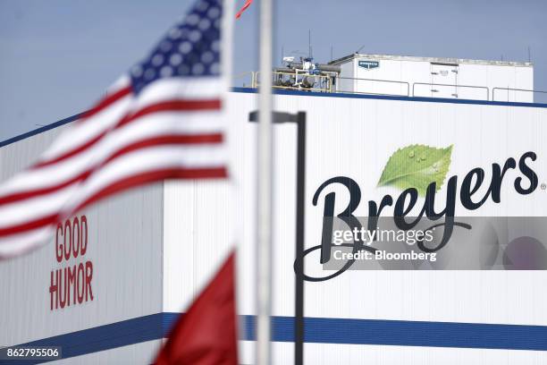 An American flag flies in front of Breyers and Good Humor brand signage outside the Unilever Plc facility in Covington, Tennessee, U.S., on Tuesday,...