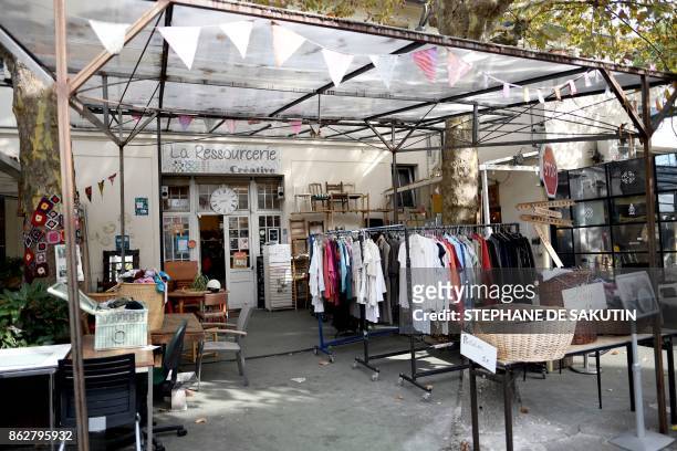 This picture taken on October 18, 2017 shows "La Ressourcerie" secondhand clothing at "Les Grands Voisins" site in Paris. - Former...