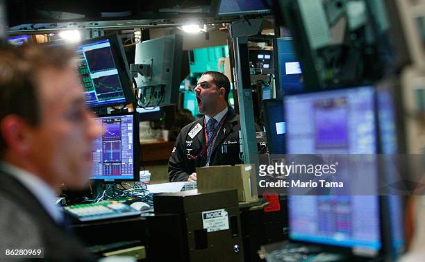 Trader yawns while working on the floor of the New York Stock Exchange moments before the Federal Reserve announcement on interest rates April 29,...