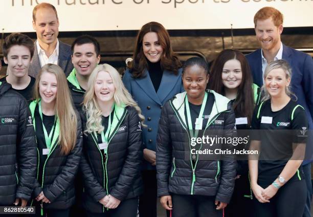 Prince William, Duke of Cambridge, Catherine, Duchess of Cambridge and Prince Harry pose with Coach Core members as they attend the Coach Core...