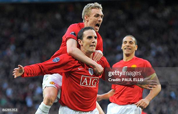 Manchester United's Irish defender John O'Shea celebrates after scoring the opening goal with Manchester United's Scottish midfielder Darren Fletcher...