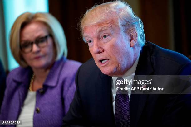 President Donald Trump speaks next to Senator Claire McCaskill of Missouri during a meeting with members of the the Senate Finance Committee in the...