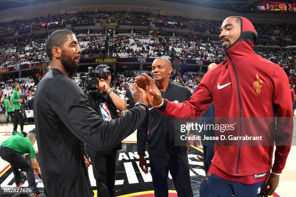 Kyrie Irving of the Boston Celtics shakes hands with JR Smith of the Cleveland Cavaliers before the game on October 17, 2017 at Quicken Loans Arena...