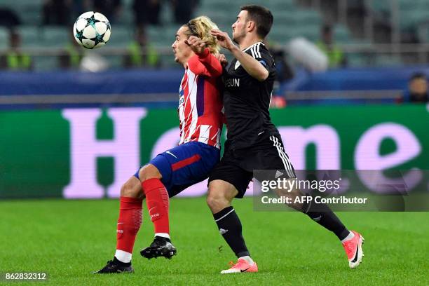 Atletico Madrid's forward from France Antoine Griezmann and Qarabag's defender from Azerbaijan Gara Garayev vie for the ball during the UEFA...