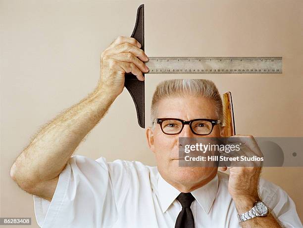 man measuring his flat top for precision - flat top stock pictures, royalty-free photos & images