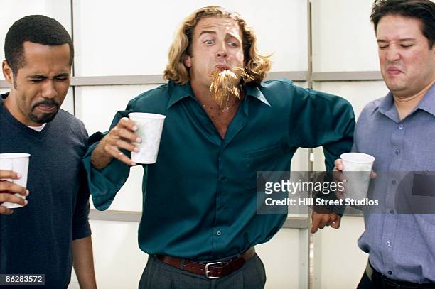 businessmen spitting out disgusting coffee - spats stock pictures, royalty-free photos & images