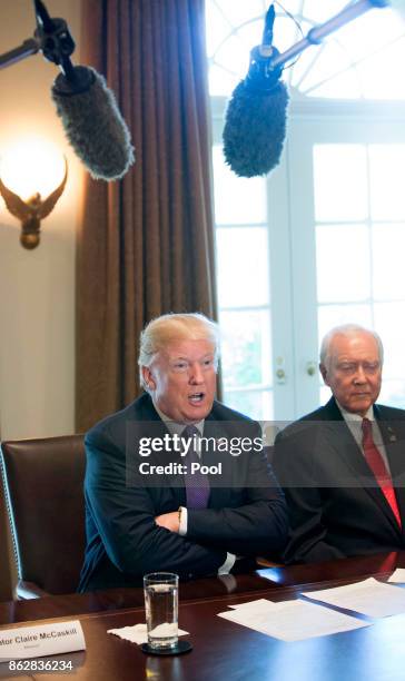 President Donald Trump, with Sen. Orrin Hatch Chairman of the Senate Finance Committee, speaks during a meeting with members of the Senate Finance...