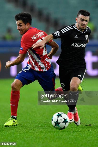 Atletico Madrid's midfielder from Argentina Nico Gaitan and Qarabag's defender from Azerbaijan Gara Garayev vie for the ball during the UEFA...