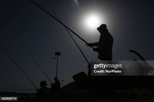 Palestinian fishermen fishes at the port in Gaza city in Gaza City on October 18, 2017 on the first day that fishermen will be allowed by Israel to...
