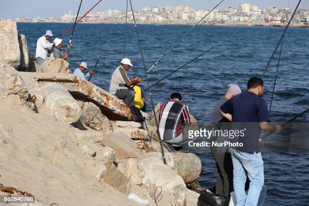 Palestinian fishermen fishes at the port in Gaza city in Gaza City on October 18, 2017 on the first day that fishermen will be allowed by Israel to...