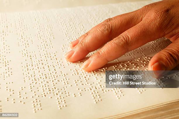 hand on braille book - visual impairment stock-fotos und bilder