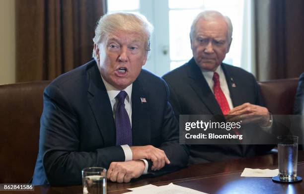 President Donald Trump speaks as Senator Orrin Hatch, a Republican from Utah and chairman of the Senate Finance Committee, right, listens during a...