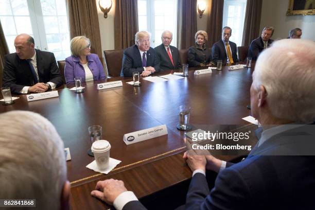 President Donald Trump, center, speaks as Gary Cohn, director of the U.S. National Economic Council, from top left, Senator Claire McCaskill, a...