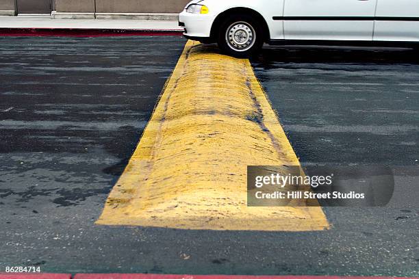 car and speed bump - speed bump stock pictures, royalty-free photos & images