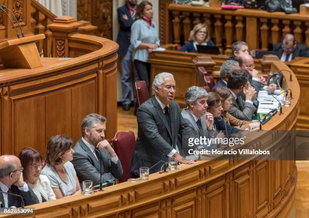 Portuguese Prime Minister Antonio Costa is flanked by his cabinet of ministers while answering to lawmakers questions on Portugal's recent forest...