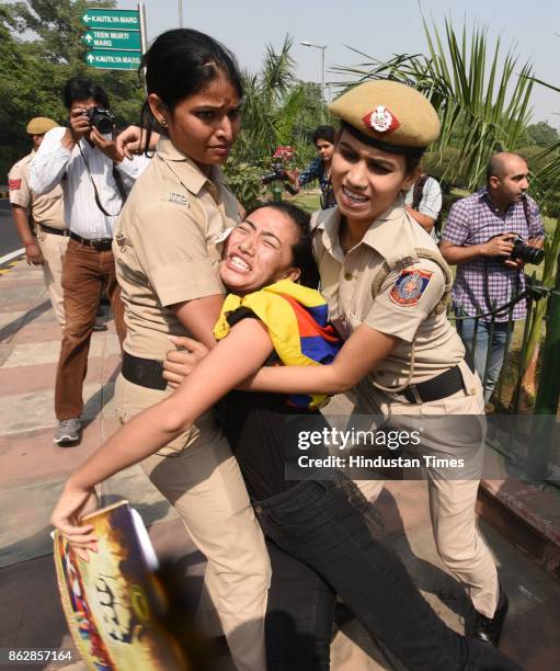 Exile Tibetans shout slogans as police detain them during a protest near the Chinese Embassy on October 18, 2017 in New Delhi, India. Nearly two...