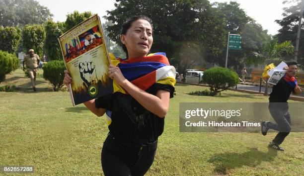 Exile Tibetans shout slogans as police detain them during a protest near the Chinese Embassy on October 18, 2017 in New Delhi, India. Nearly two...