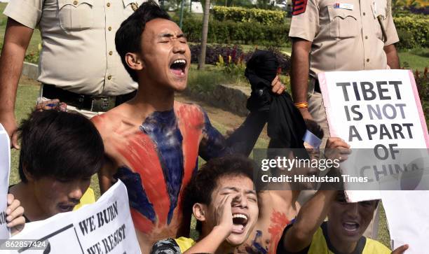 Exile Tibetans shout slogans as police detain them during a protest near the Chinese Embassy on October 18, 2017 in New Delhi, India. Nearly two...