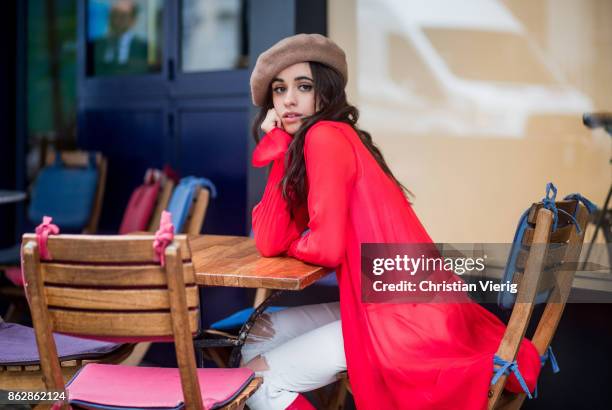 Camila Cabello wearing red kimono Ulyana Sergeenko, white pants, brown beret, red Stuart Weitzman boots is seen on October 18, 2017 in London,...