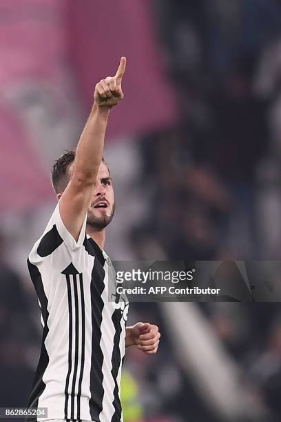 Juventus midfielder Miralem Pjanic celebrates after scoring during the UEFA Champions League Group D football match Juventus vs Sporting CP at the...