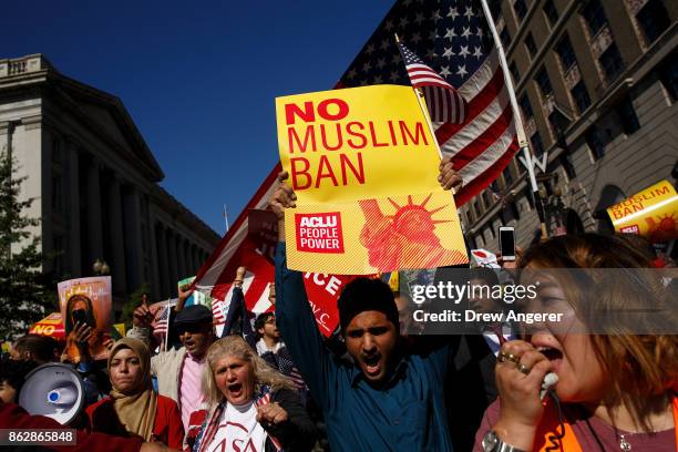 Following a rally in Lafayette Park, activists march toward Trump International Hotel during a protest against the Trump administration's proposed...