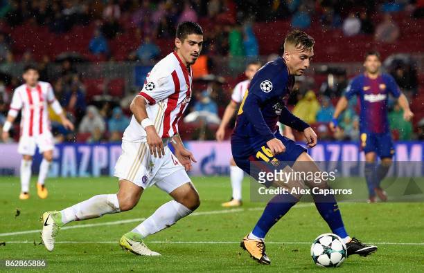 Dimitris Nikolaou of Olympiacos puts pressure on Gerard Deulofeu of Barcelona during the UEFA Champions League group D match between FC Barcelona and...
