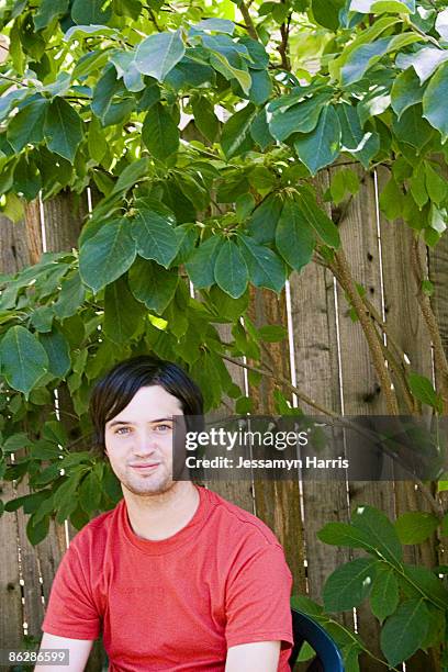 man by wooden fence - jessamyn harris stock pictures, royalty-free photos & images