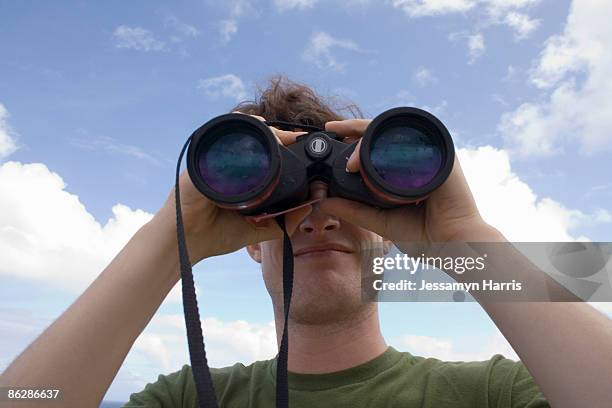 man looking through binoculars - jessamyn harris stock pictures, royalty-free photos & images