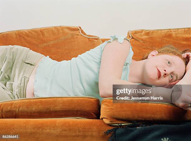 woman resting on sofa - jessamyn harris stock pictures, royalty-free photos & images