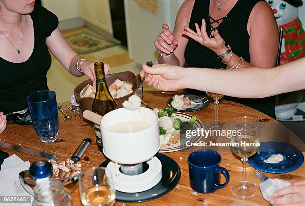 people eating fondue - jessamyn harris stock pictures, royalty-free photos & images