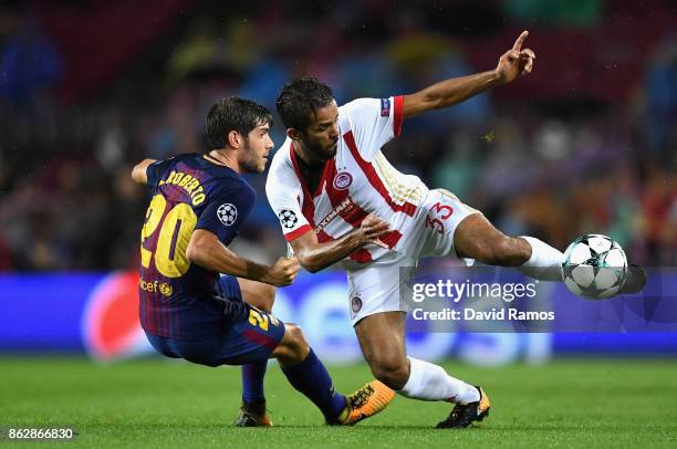 Leonardo Koutris of Olympiacos and Sergi Roberto of Barcelona battle for possession during the UEFA Champions League group D match between FC...