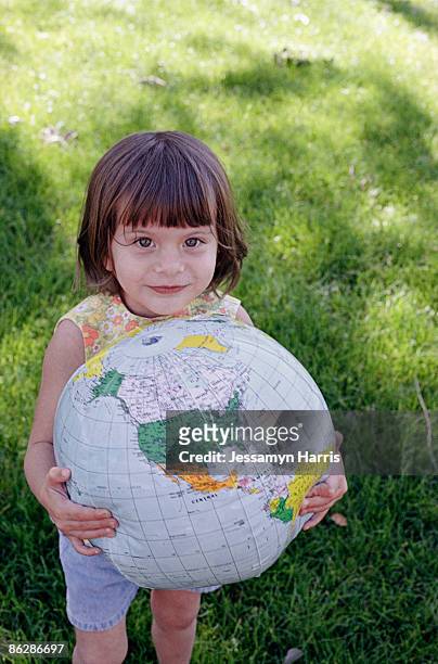 girl holding globe - jessamyn harris stock pictures, royalty-free photos & images