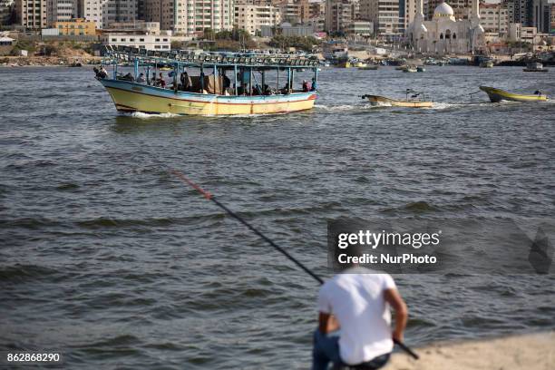 Palestinian fishermen set off for the sea in Gaza City on October 18, 2017 on the first day that fishermen will be allowed by Israel to travel up to...