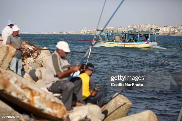Palestinian fishermen set off for the sea in Gaza City on October 18, 2017 on the first day that fishermen will be allowed by Israel to travel up to...