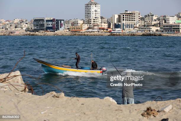 Palestinian fishermen set off for the sea in Gaza City on October 18, 2017 on the first day that fishermen will be allowed by Israel to travel up to...