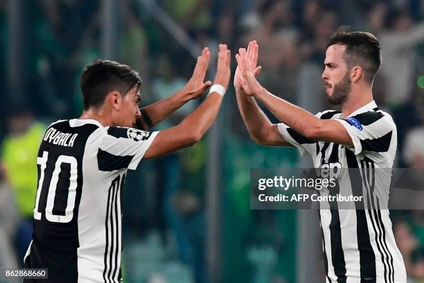 Juventus midfielder Miralem Pjanic celebrates with Juventus' forward from Argentina Paulo Dybala after scoring during the UEFA Champions League Group...