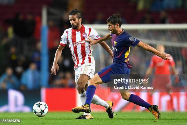 Leonardo Koutris of Olympiacos and Sergi Roberto of Barcelona battle for posession during the UEFA Champions League group D match between FC...