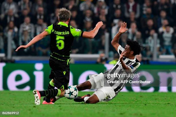 Juventus' forward from Colombia Juan Cuadrado fights for the ball with Sporting's midfielder Fabio Coentrao during the UEFA Champions League Group D...