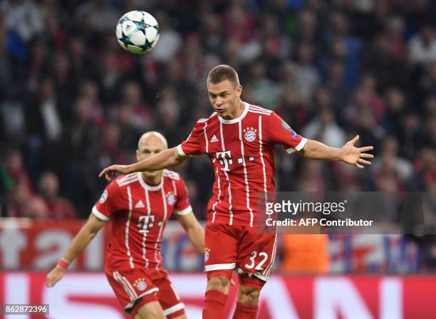 Bayern Munich's midfielder Joshua Kimmich heads the second goal during the Champions League group B match between FC Bayern Munich and Celtic Glasgow...