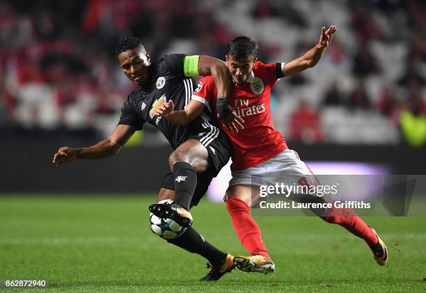 Antonio Valencia of Manchester United and Diogo Antonio Cupido Goncalves of Benfica battle for possession during the UEFA Champions League group A...