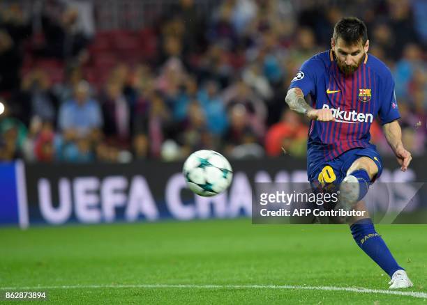Barcelona's Argentinian forward Lionel Messi shoots to score his goal number 100 in a European competition during the UEFA Champions League group D...