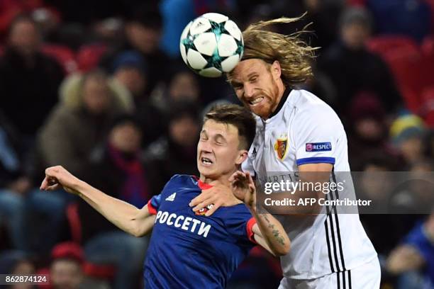 Moscow's midfielder from Russia Aleksandr Golovin and Basel's defender from Switzerland Michael Lang vie for the ball during the UEFA Champions...